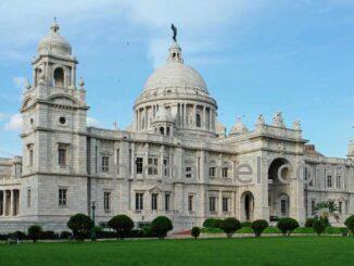 Kolkata Photo Fort, "Victoria Memorial in Kolkata, India, a large white marble building with domes and towers, set against a blue sky."